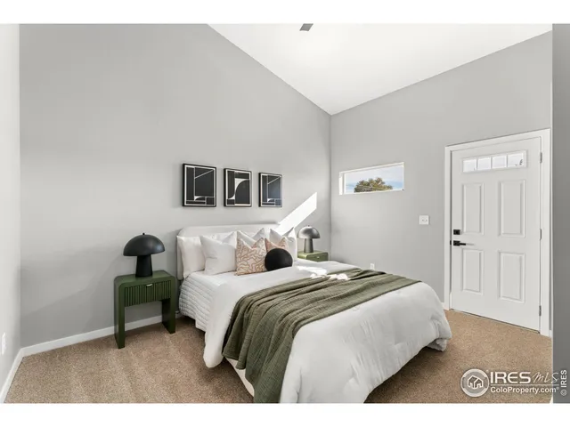 a bedroom with a bed and a night stand