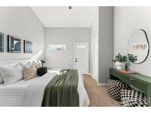 a bedroom with a bed and a potted plant