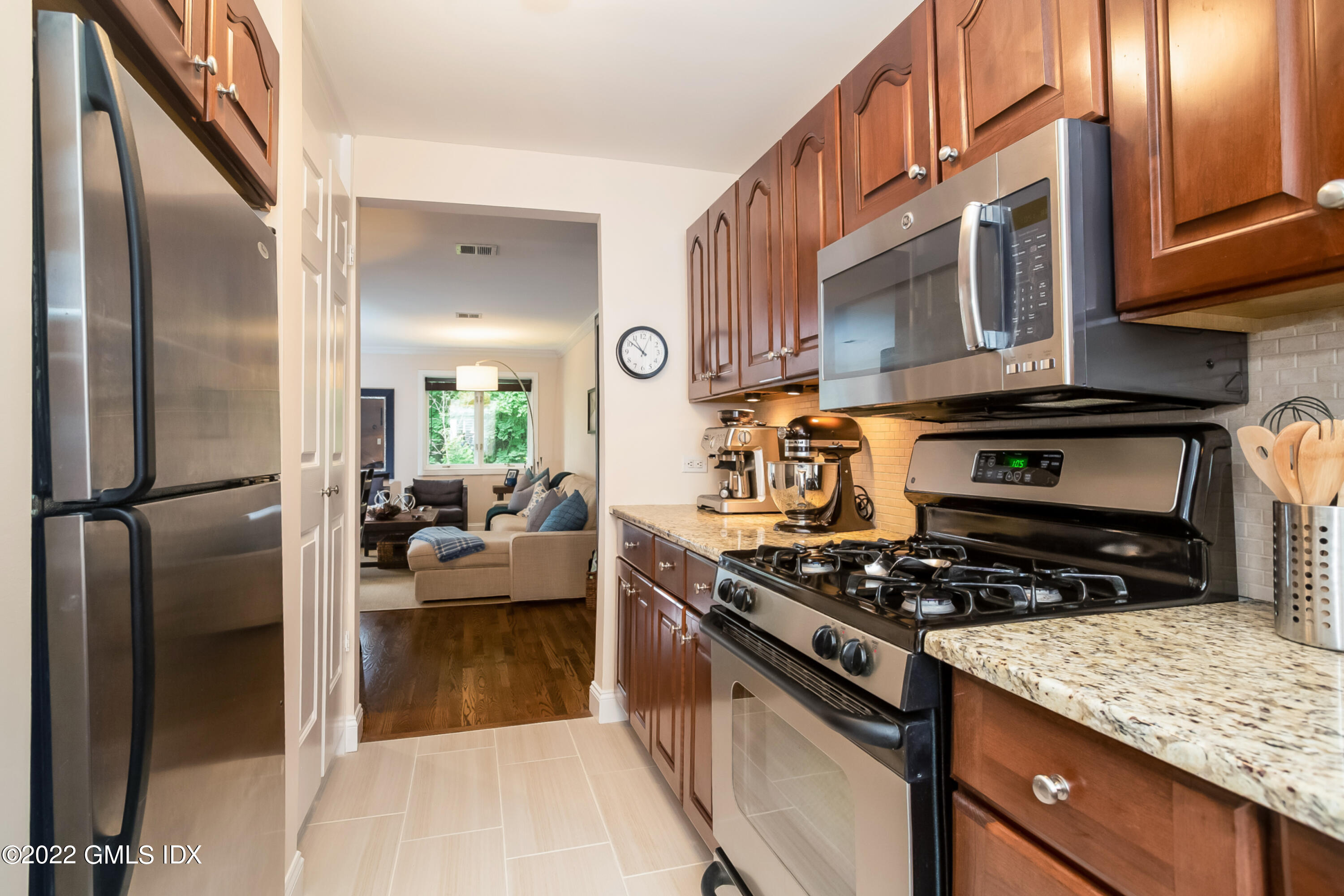 453 East Putnam Avenue, Unit 4H Cos Cob, CT 06807 - Photo 11 of 31 a kitchen with stainless steel appliances granite countertop a stove a sink and a refrigerator