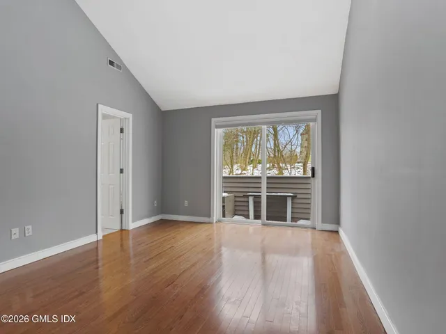 a bathroom with a toilet a sink a vanity and mirror