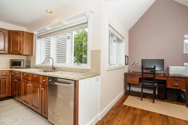 a kitchen with granite countertop a sink and a stove top oven