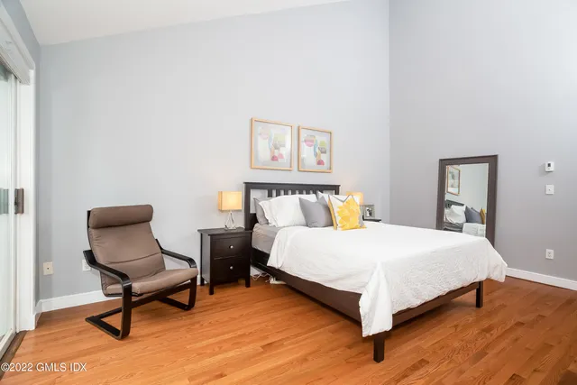 a bedroom with a bed and chair