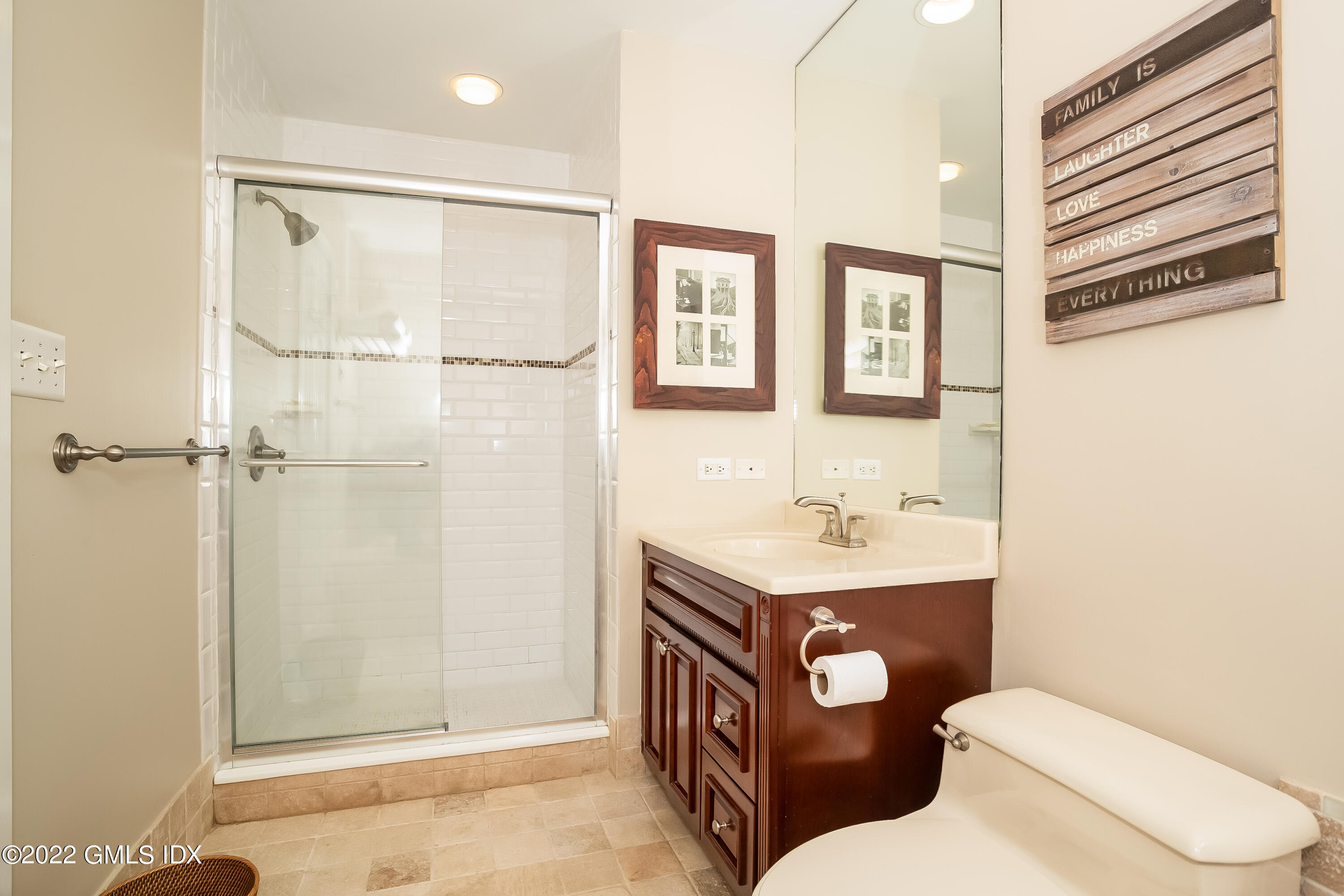 453 East Putnam Avenue, Unit 4H Cos Cob, CT 06807 - Photo 19 of 31 a bathroom with a toilet a sink and mirror