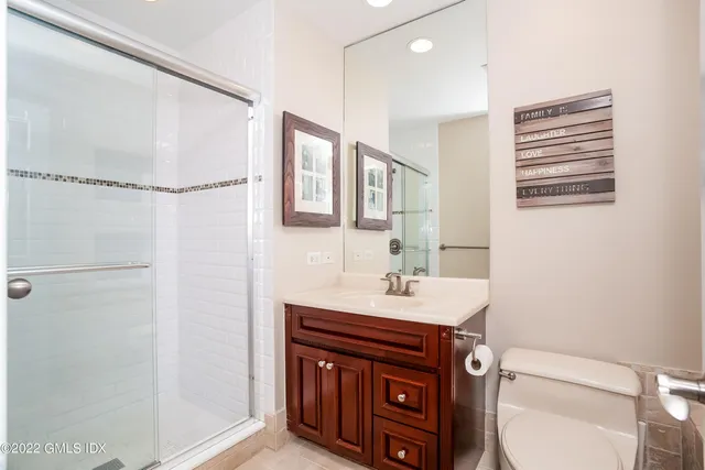 a bathroom with a sink toilet and mirror