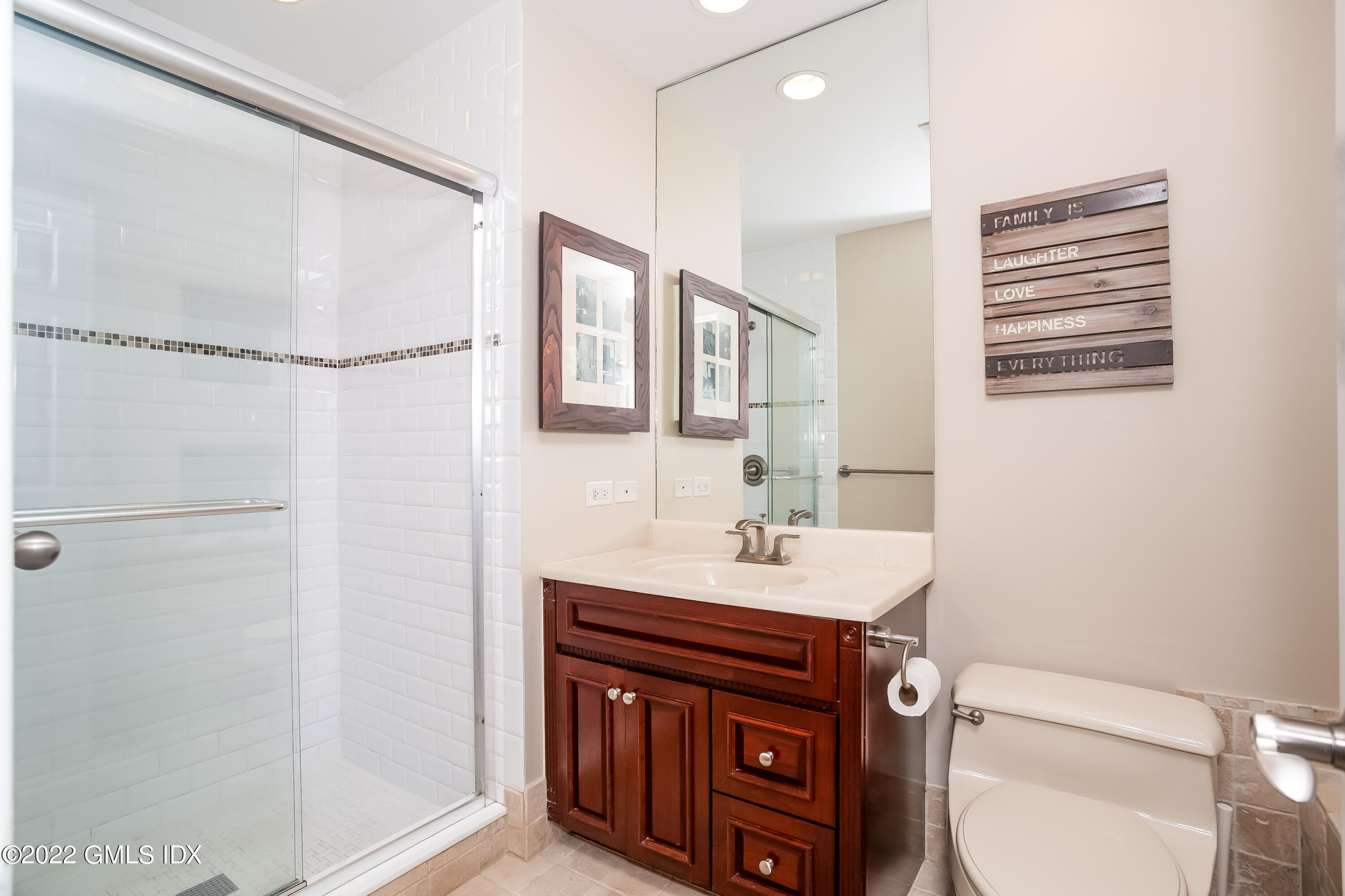 453 East Putnam Avenue, Unit 4H Cos Cob, CT 06807 - Photo 21 of 31 a bathroom with a sink toilet and mirror