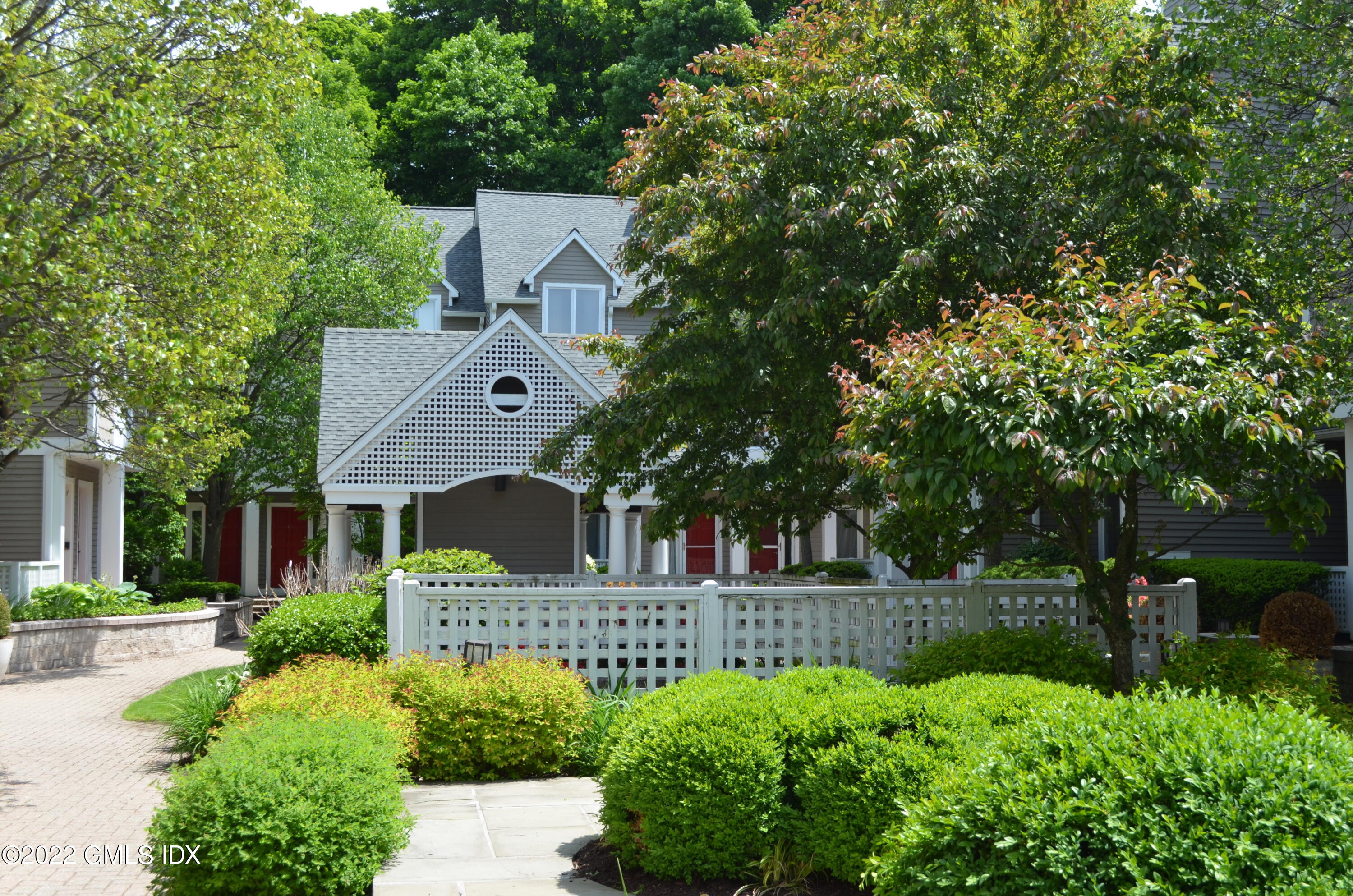 453 East Putnam Avenue, Unit 4H Cos Cob, CT 06807 - Photo 26 of 31 a front view of a house with a yard