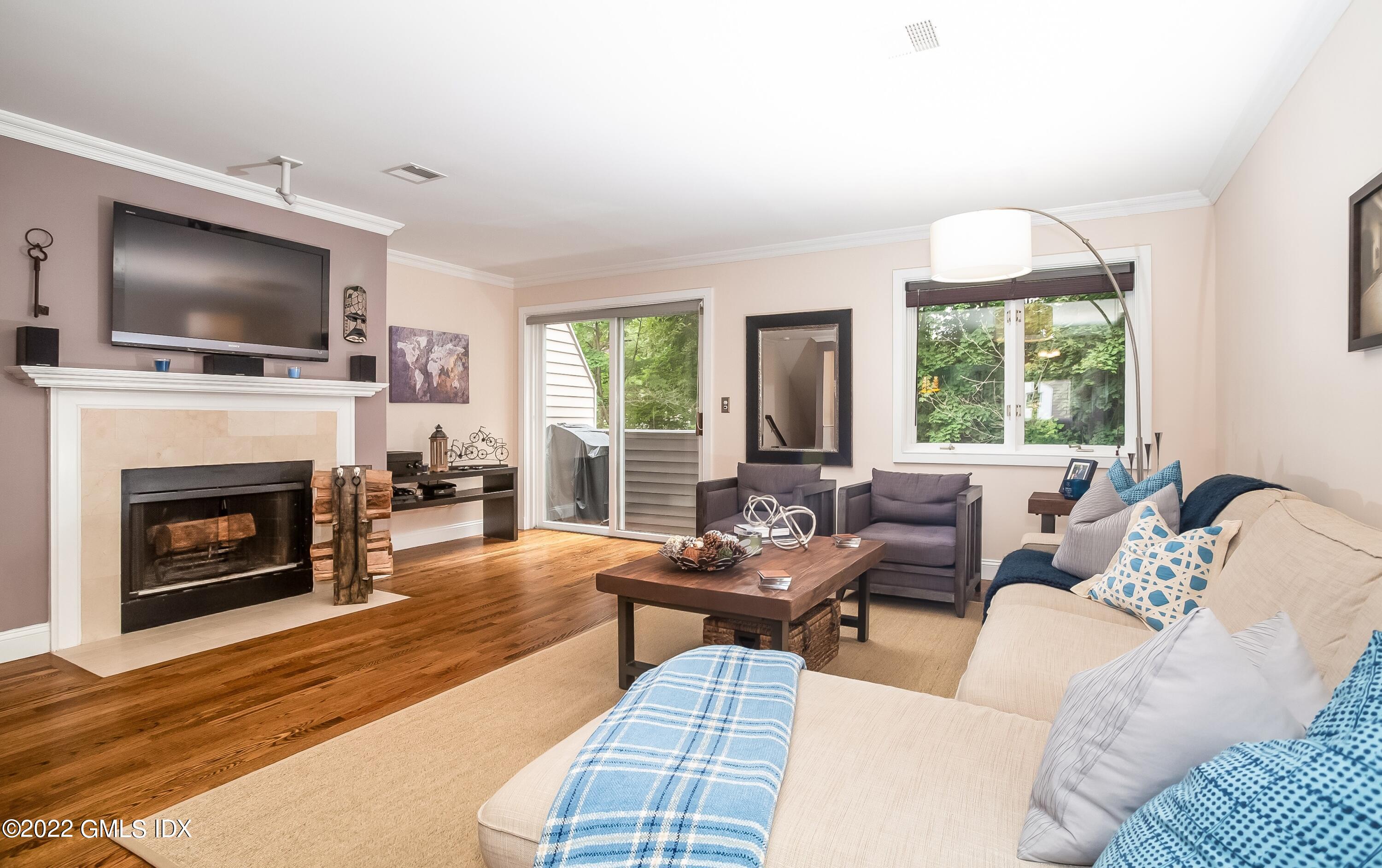 453 East Putnam Avenue, Unit 4H Cos Cob, CT 06807 - Photo 5 of 31 a living room with furniture fireplace and flat screen tv