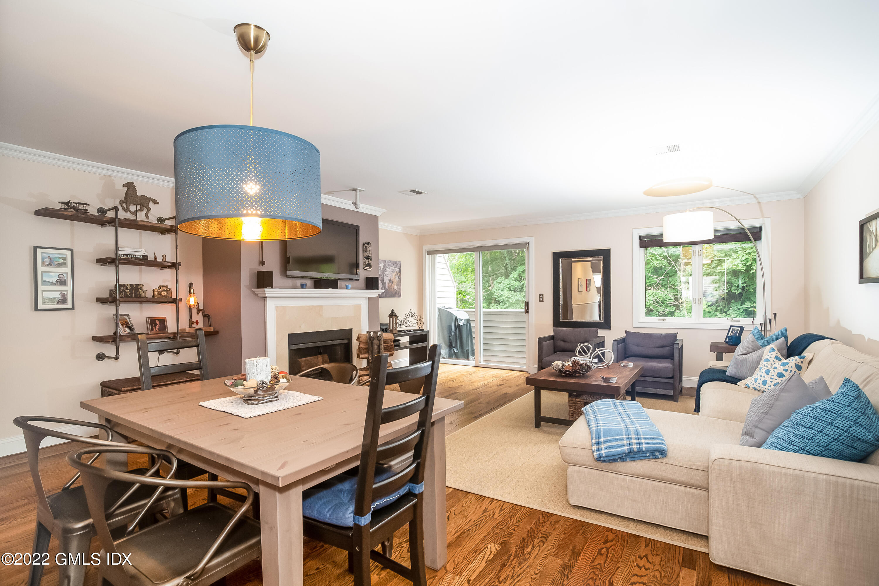 453 East Putnam Avenue, Unit 4H Cos Cob, CT 06807 - Photo 6 of 31 a living room with fireplace furniture and a large window