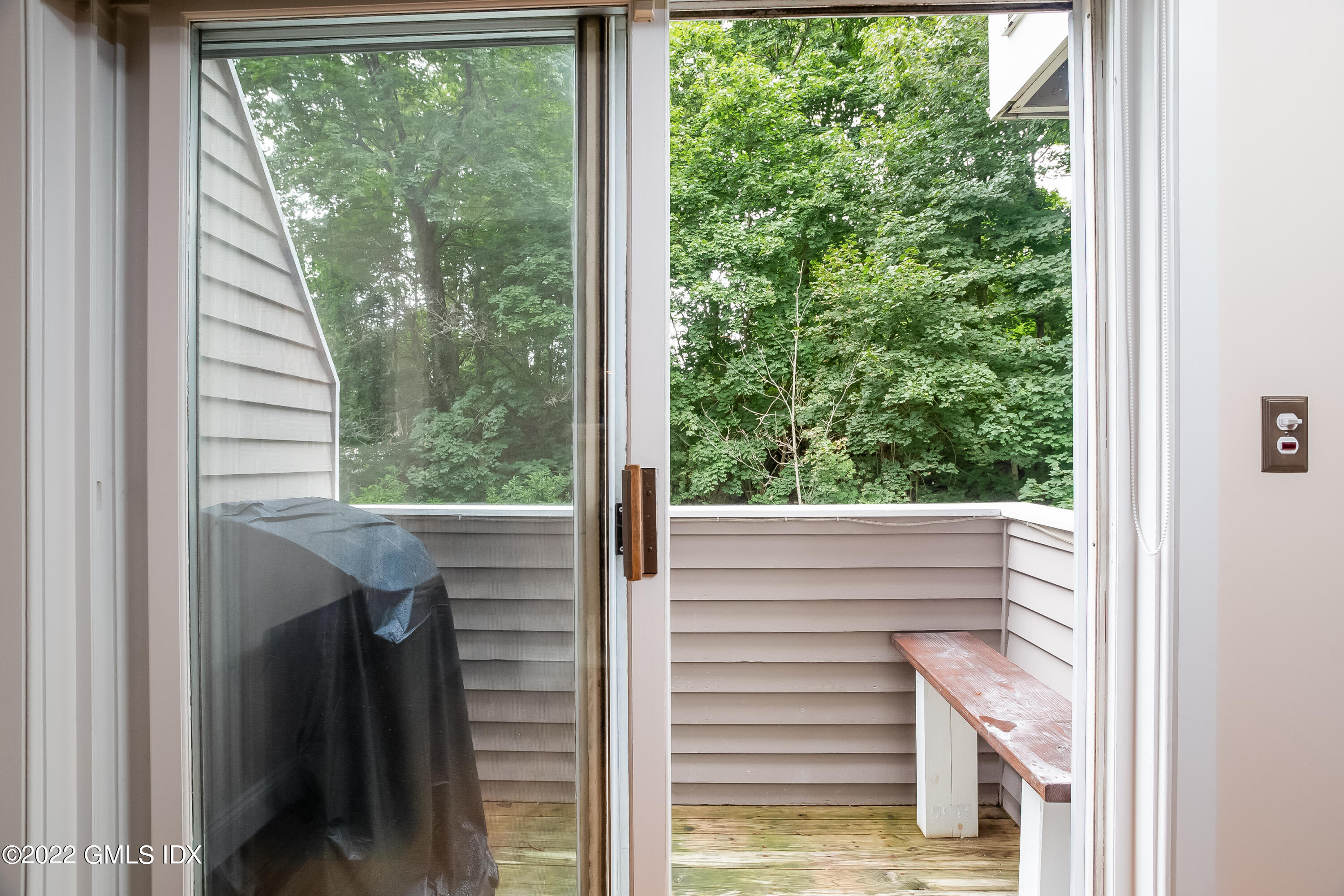 453 East Putnam Avenue, Unit 4H Cos Cob, CT 06807 - Photo 7 of 31 a view of a glass door with a yard from a window