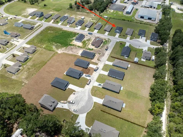 an aerial view of residential house with outdoor space and parking