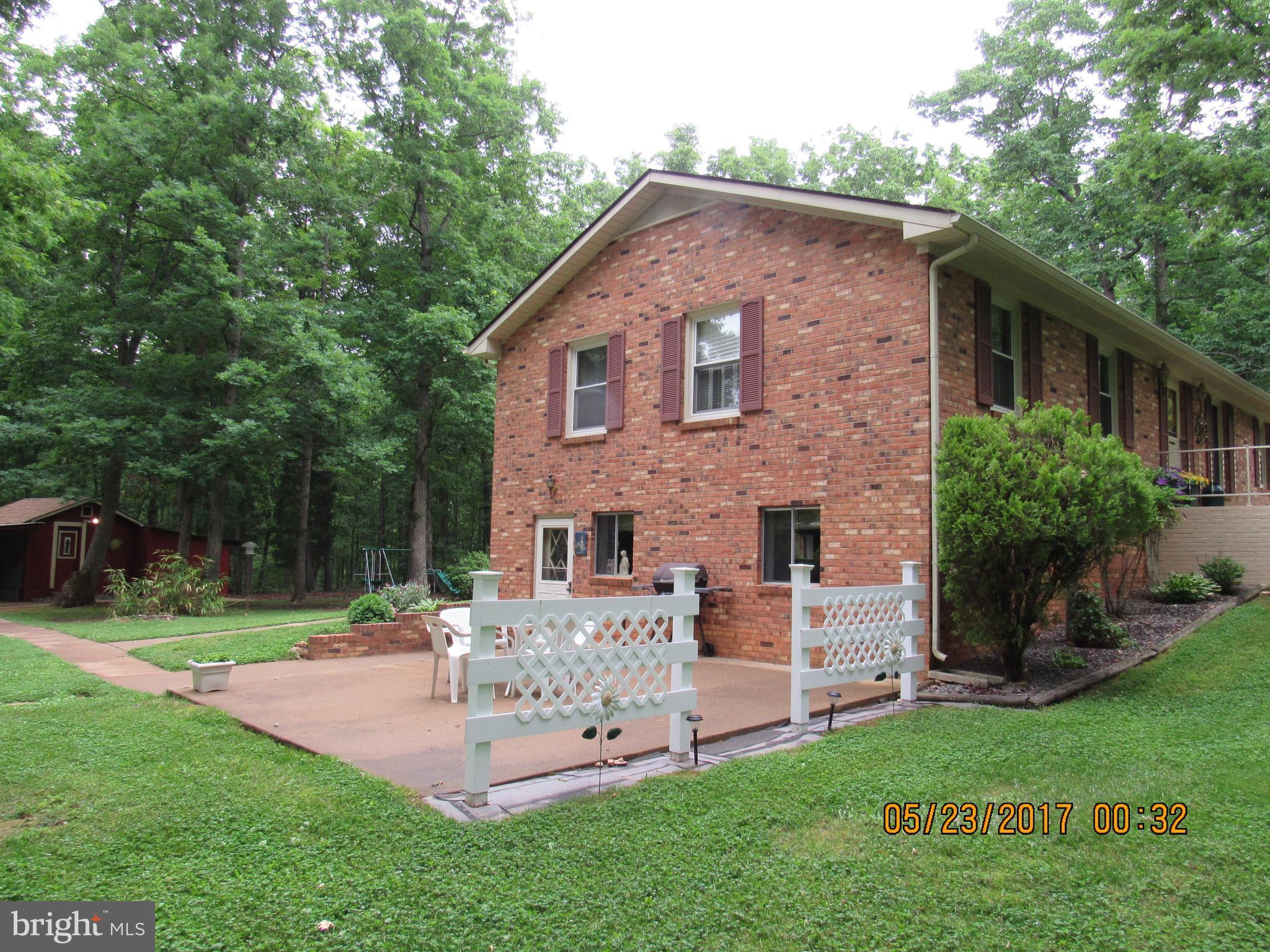 29057 Lacewood Road Rhoadesville, VA 22542 - Photo 16 of 22 side and patio off basement exterior access