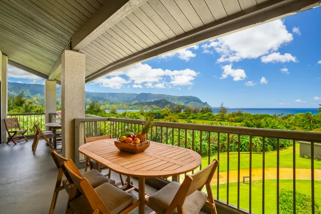 a view of a balcony with a table and chairs