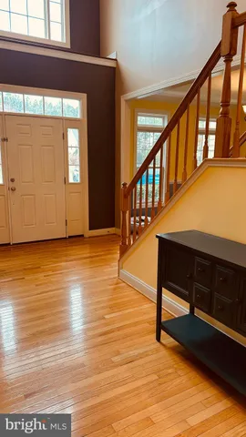 a living room with furniture and a mirror