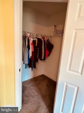 a bedroom with a bed flat screen tv and a large window