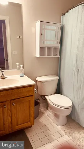 a hallway with a wooden floor and a cabinet