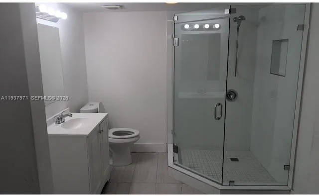 a bathroom with a toilet sink and shower