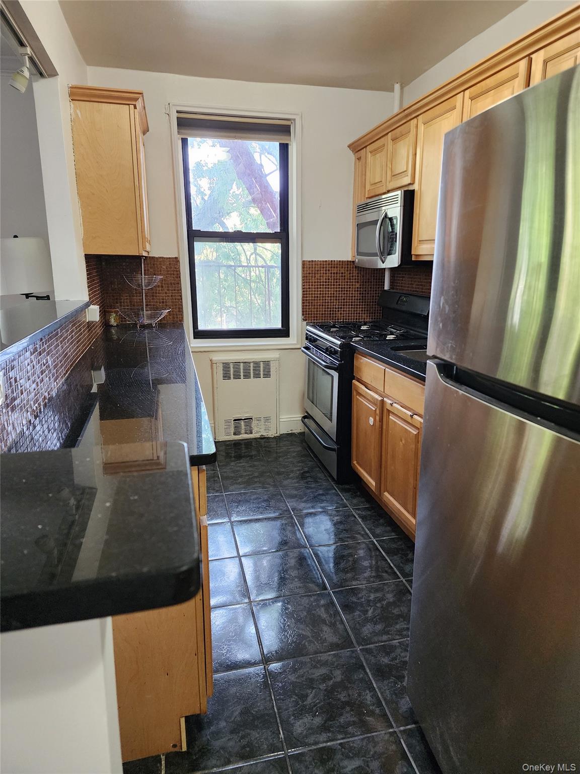 a kitchen with sink a refrigerator and a stove