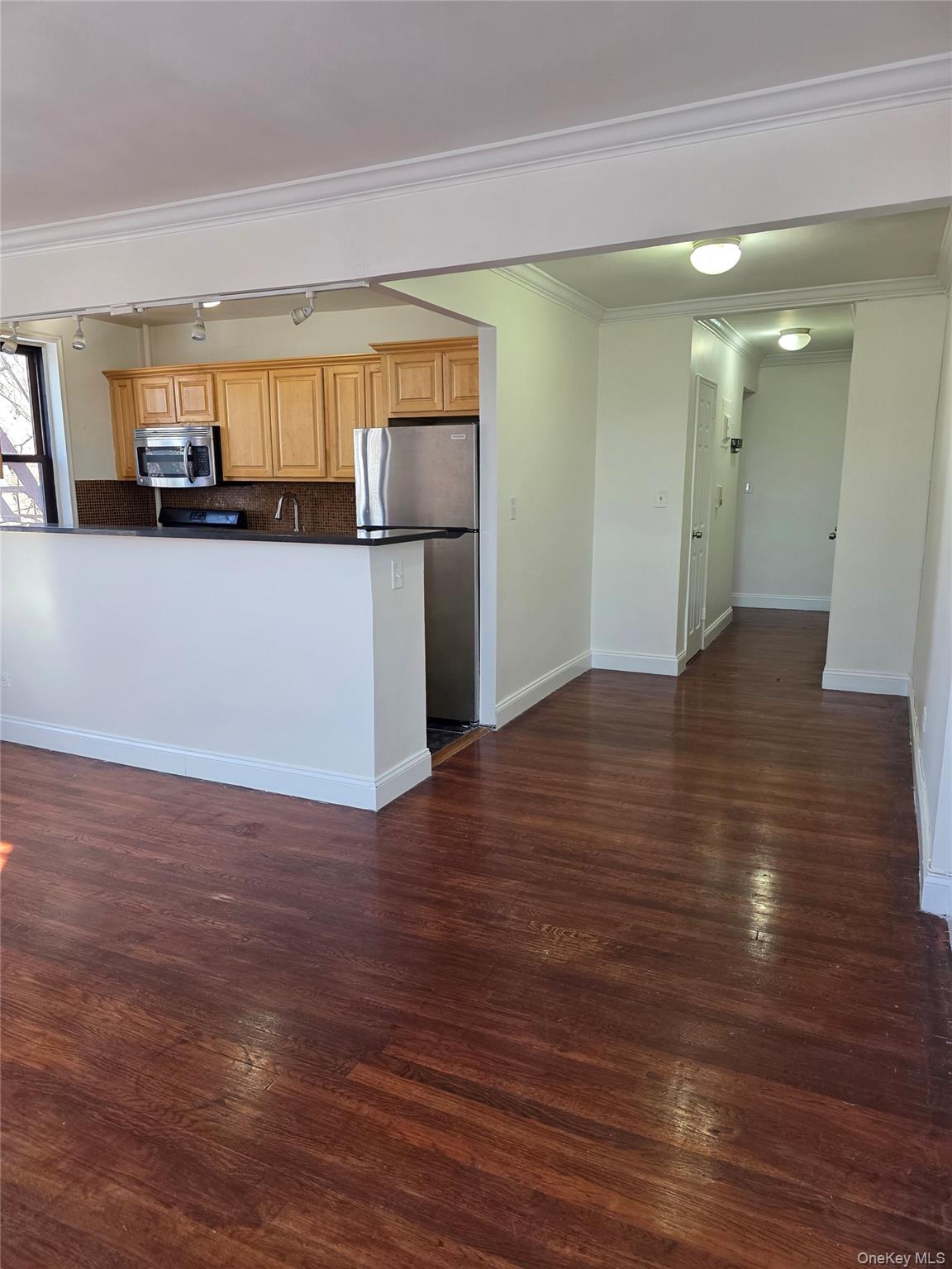 150-11 72nd Road Queens, NY 11367 - Photo 3 of 8 a view of a kitchen with wooden floor and a window