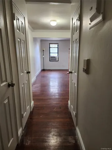 a view of hallway with stairs and wooden floor