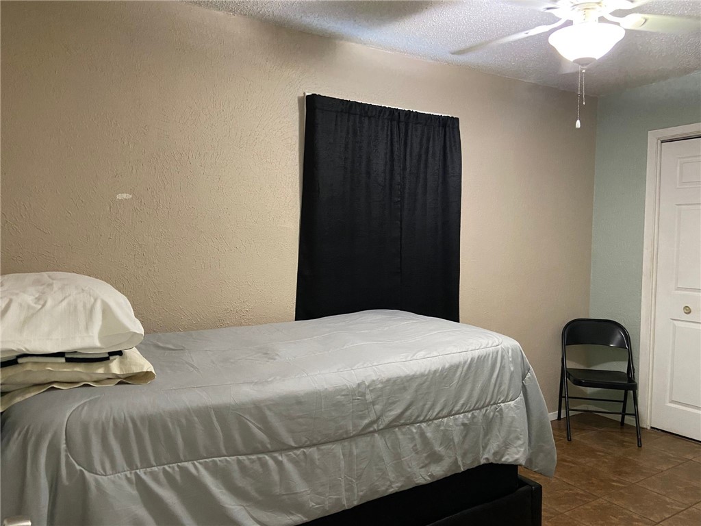 2102 Suarez Street Alice, TX 78332 - Photo 7 of 11 a bedroom with a bed and a cabinets