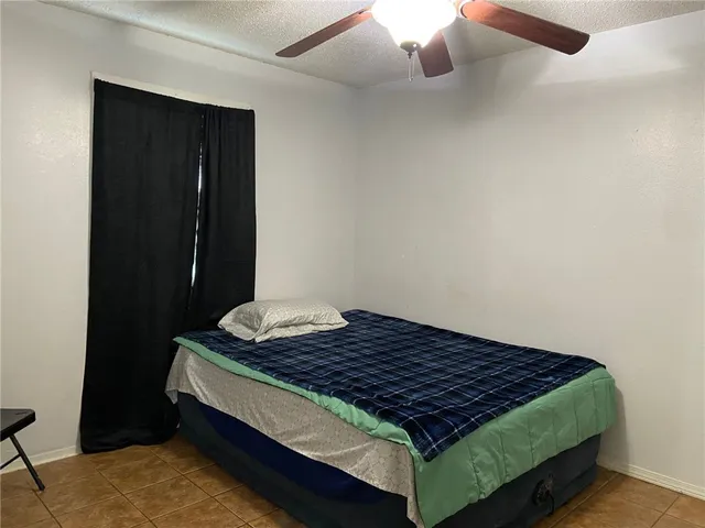 a bed sitting in a bedroom next to a cabinet