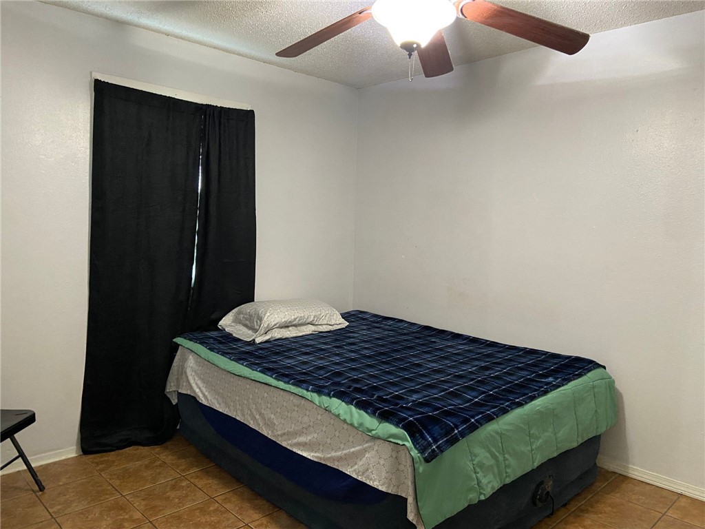 2102 Suarez Street Alice, TX 78332 - Photo 8 of 11 a bed sitting in a bedroom next to a cabinet