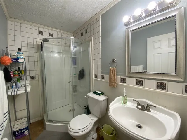 a bathroom with a sink toilet and shower