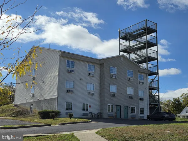 a view of a building with a yard