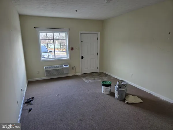 an empty room with water heater and windows