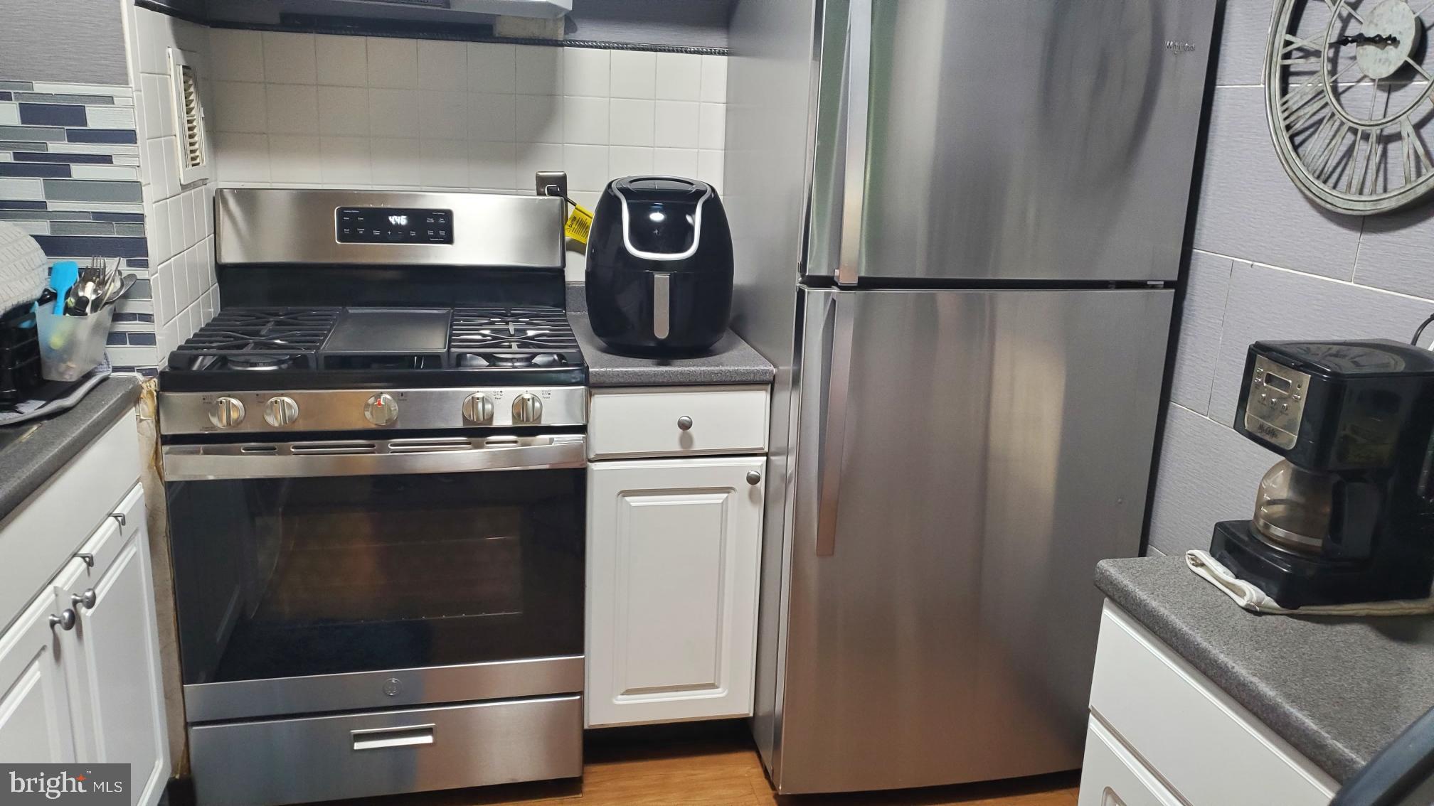 1822 Metzerott Road, Unit 105 Adelphi, MD 20783 - Photo 6 of 14 a stove top oven sitting inside of a kitchen