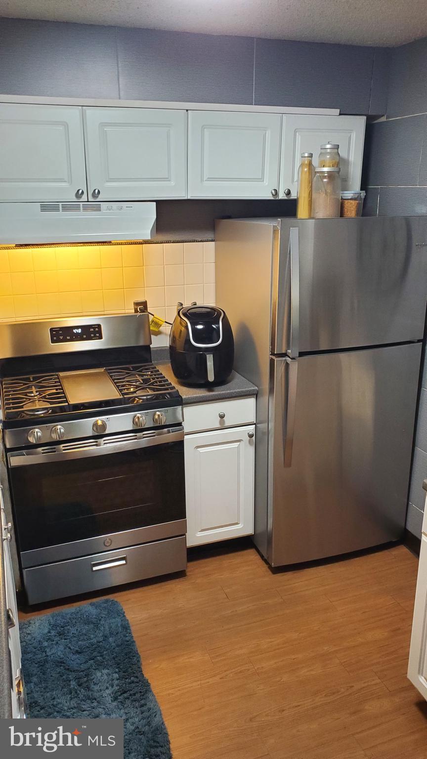 1822 Metzerott Road, Unit 105 Adelphi, MD 20783 - Photo 7 of 14 a kitchen with appliances and cabinets