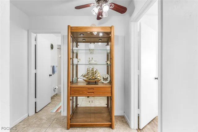 a view of a hallway with wooden floor and a cabinet