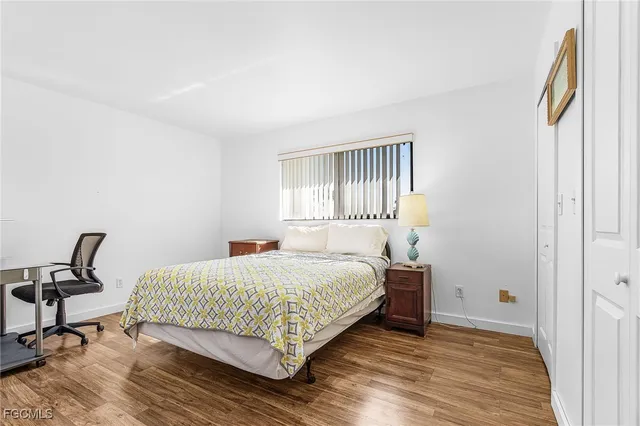 a bedroom with a bed a chair and a window