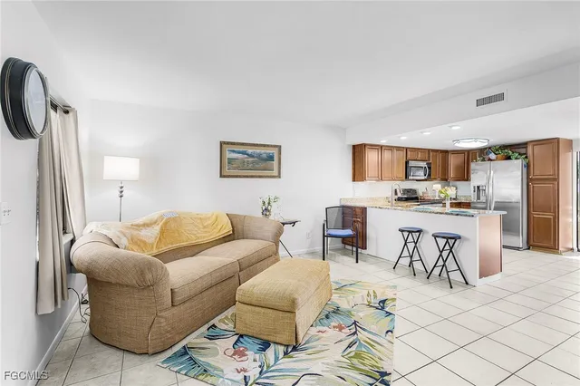 a living room with furniture and kitchen view