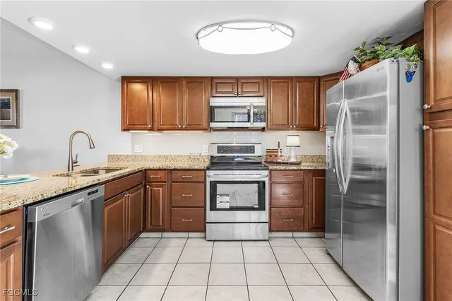 a kitchen with a refrigerator sink and cabinets