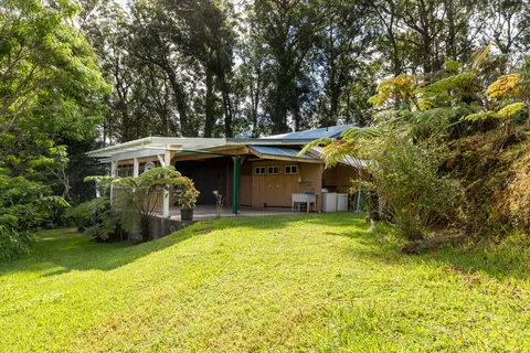 a view of a house with pool and sitting area