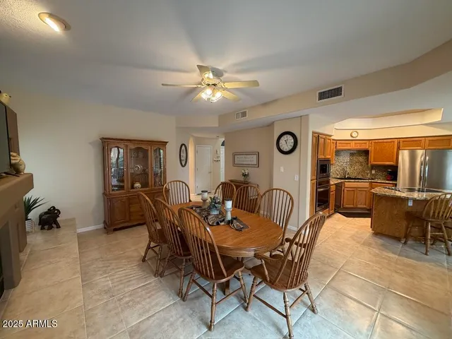 a living room with furniture a flat screen tv and a window
