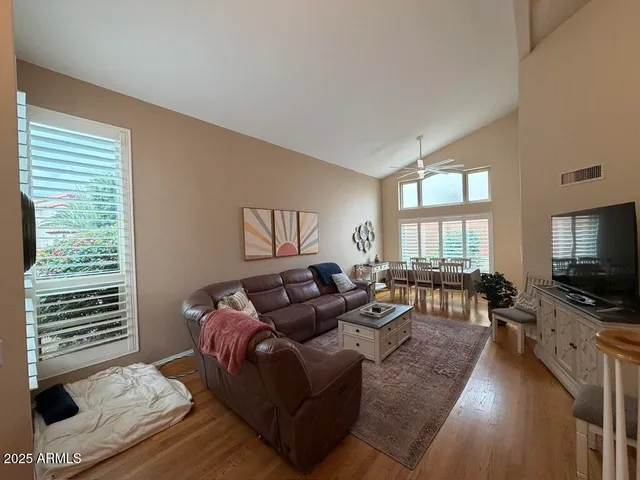 a bedroom with furniture a chandelier and wooden floor