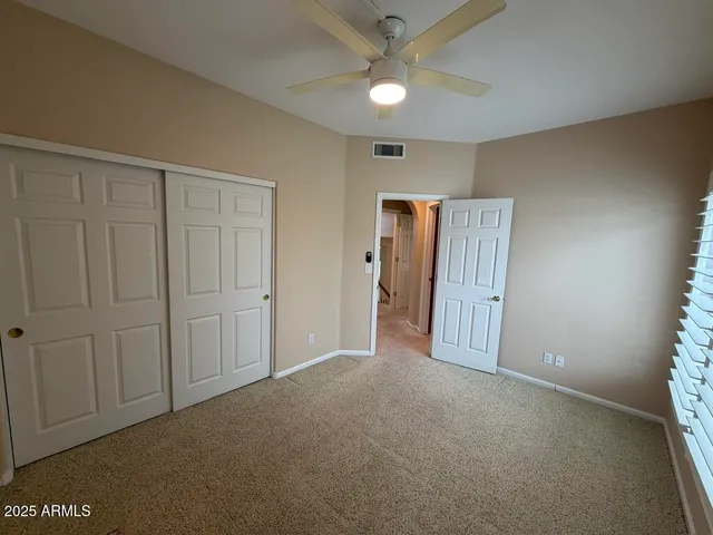 a bathroom with a tub sink vanity granite and a mirror