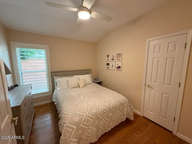 a bedroom with a large bed and a flat screen tv
