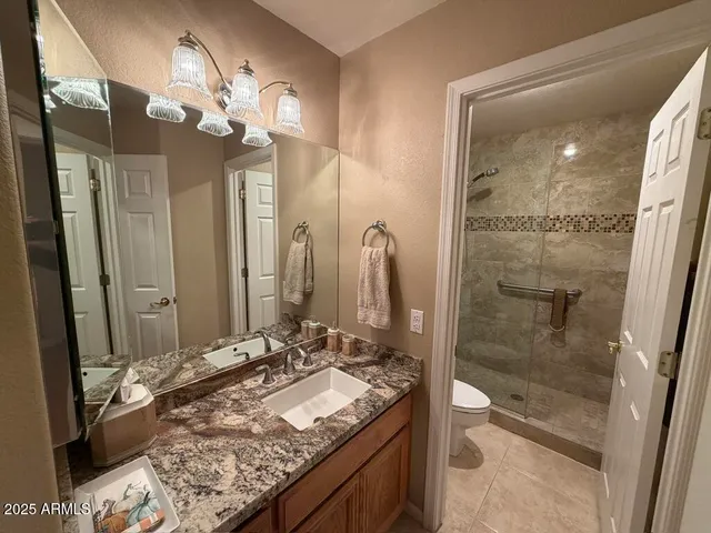 a bathroom with a shower a toilet and a sink