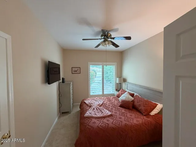 a bedroom with a bed and a flat screen tv