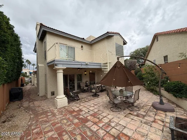 a view of a patio with a table and chairs