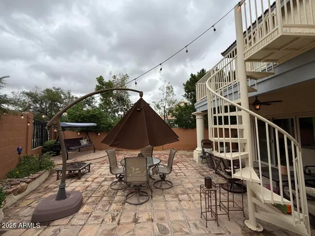a view of a patio with table and chairs and potted plants