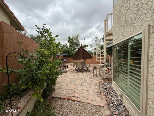 a view of a patio with couple of furniture and a table