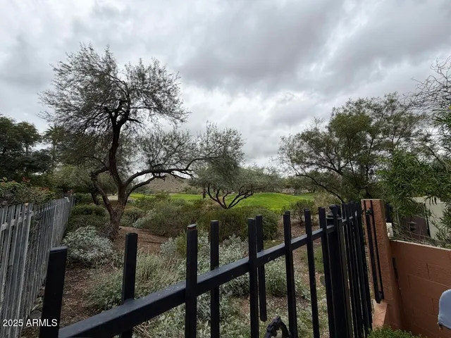 a view of a grey house with large windows