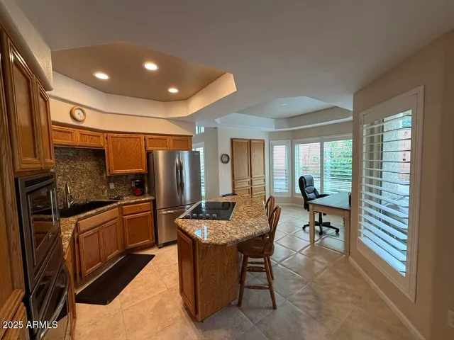 a view of a workspace with furniture and a window