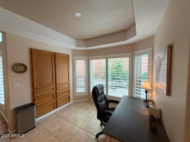 a work room with furniture and a large window