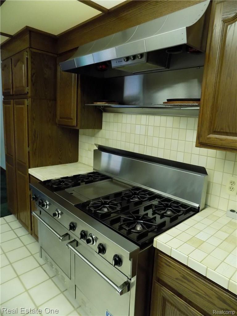 4650 Clyde Road Holly, MI 48442 - Photo 13 of 68 The Viking 6-burner stove and range hood