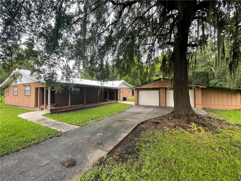 45013 Bismark Road Callahan, FL 32011 - Photo 1 of 26 a front view of a house with garden